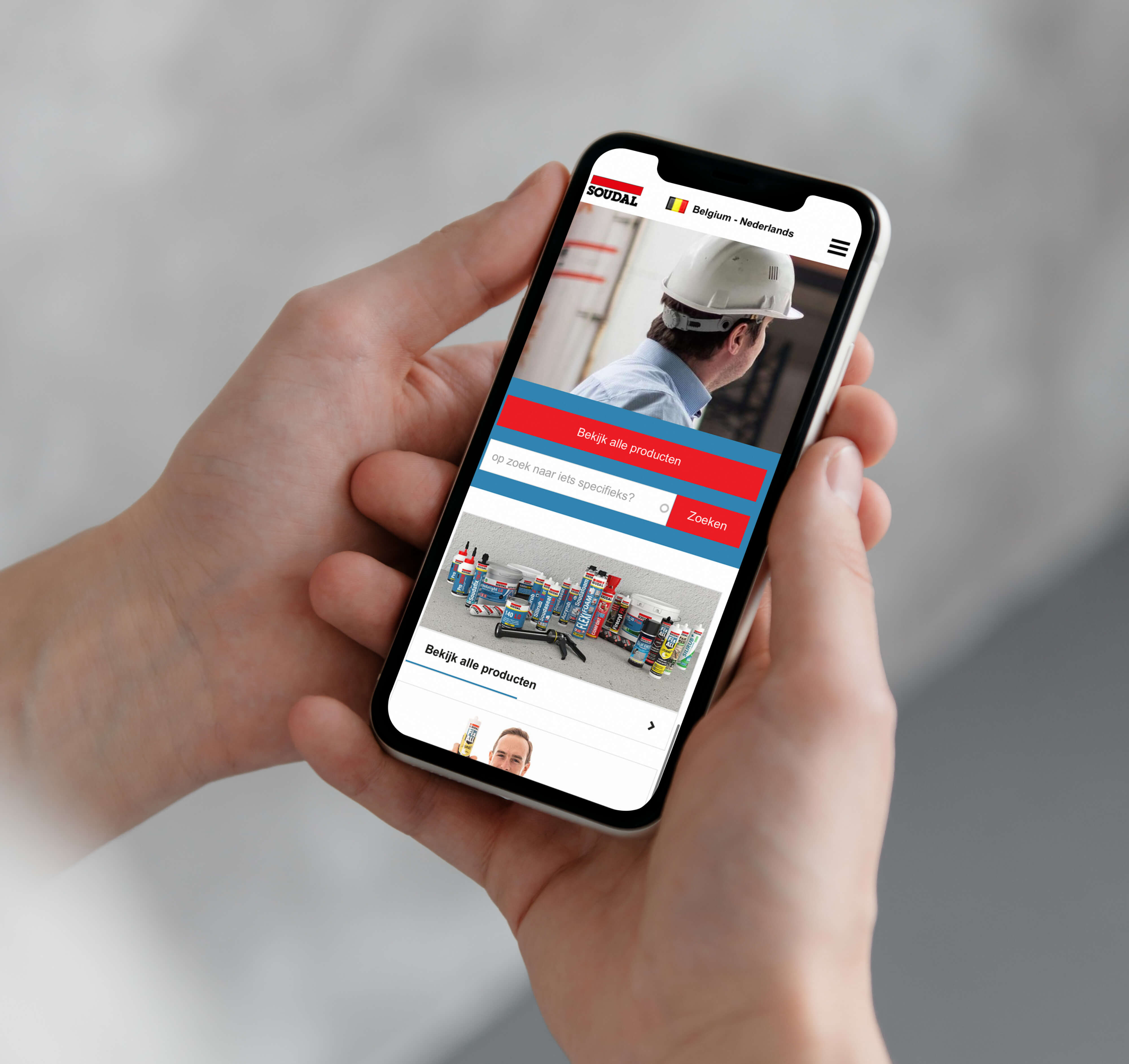 Soudal homepage mobile while hand holding phone