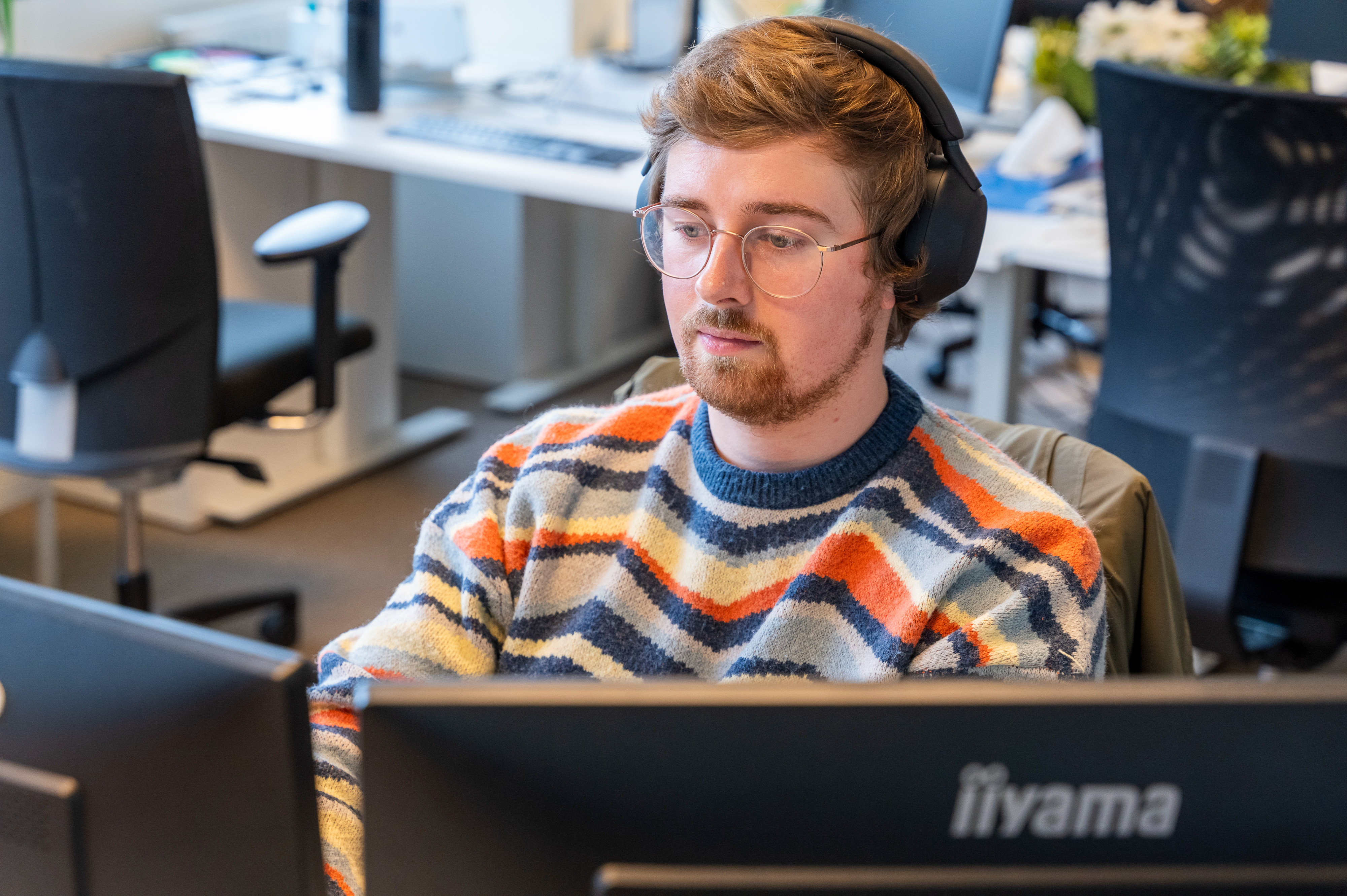 Person working behind computer